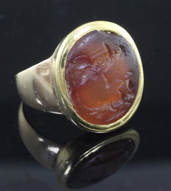 An antique gold mounted Roman? intaglio carnelian ring, size L.
